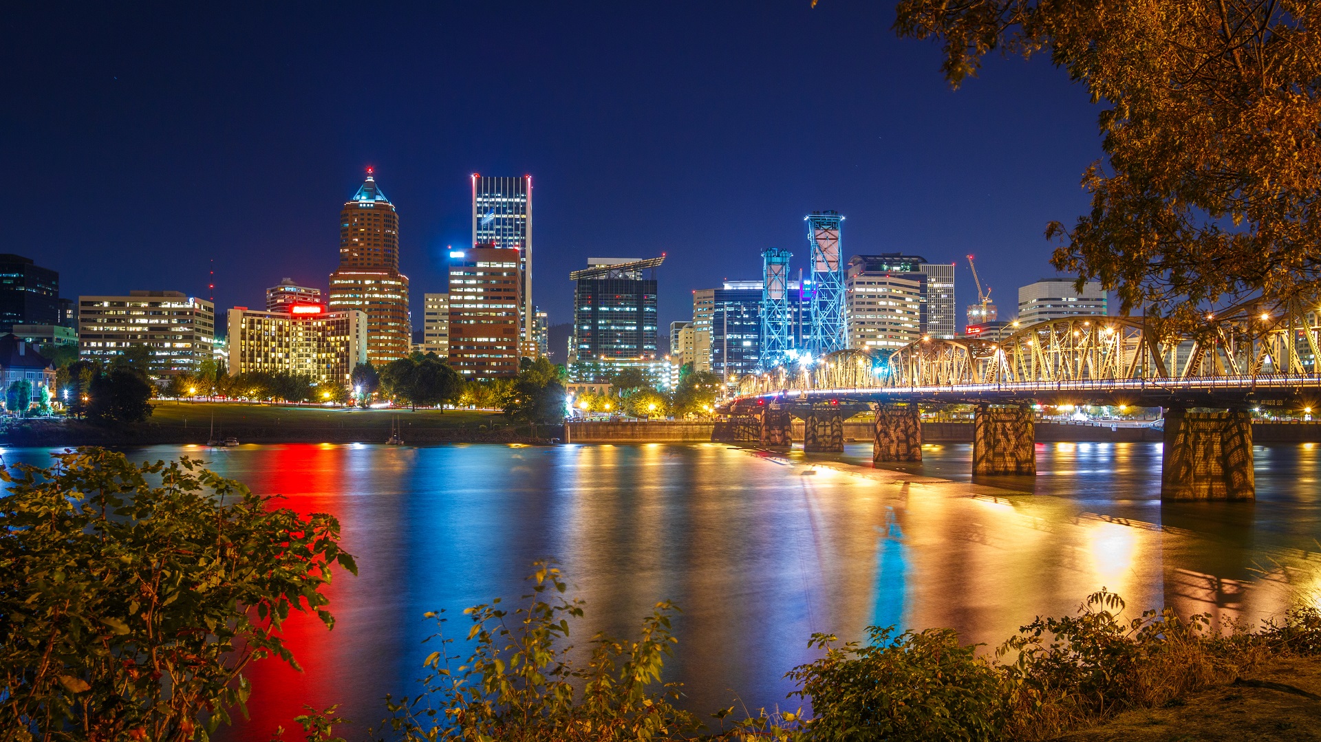 Beautiful Panorama Of Downtown Portland Cityscape Skyscrapers And Hawthorne Bridge During Late Sunset/early Night With Glowing Yellow Lights And Dark Blue Night Sky, In Portland, Oregon, Usa